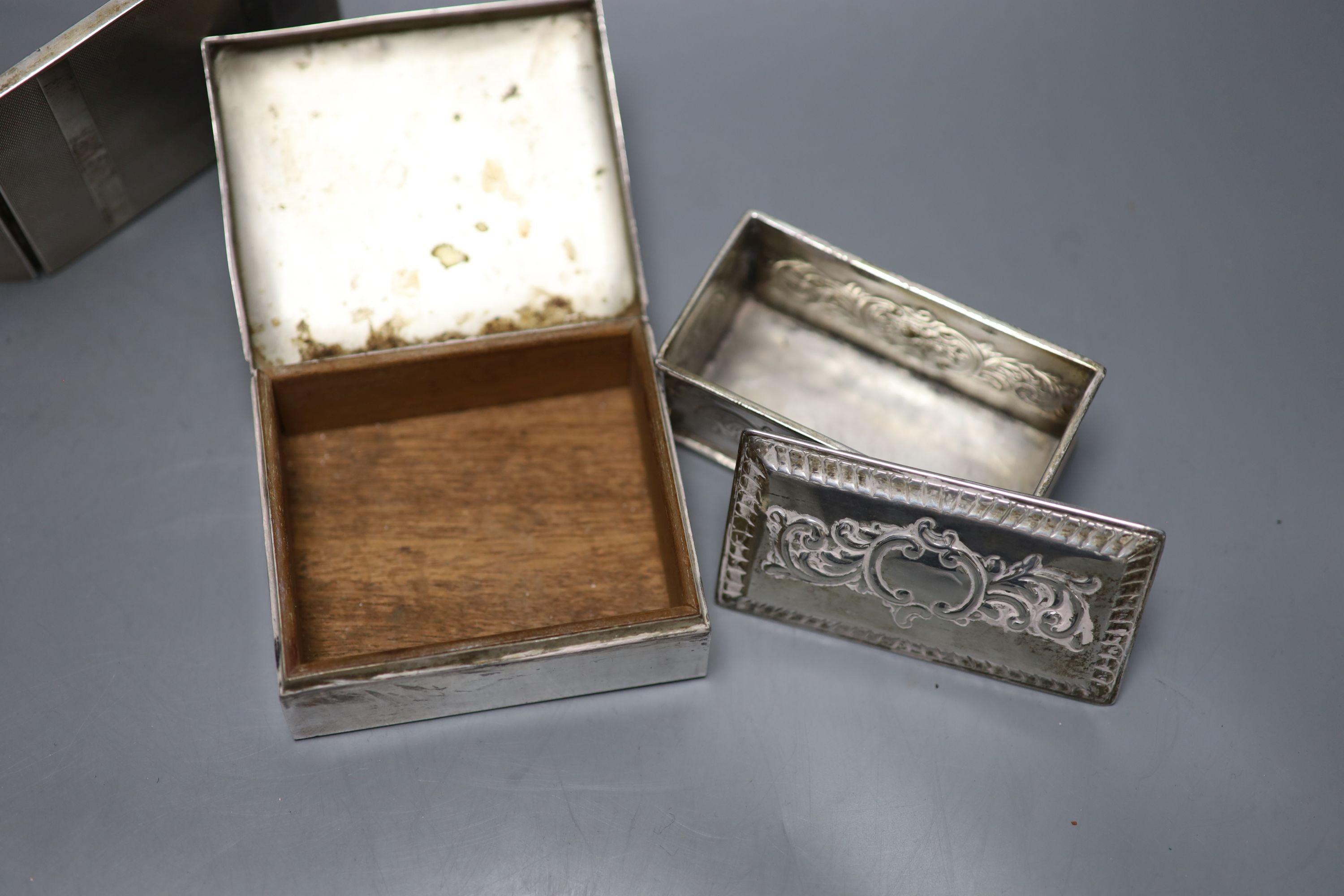 A sterling cigarete box, 9.5cm, a 900 white metal cigarette case and a late Victorian silver box and cover.